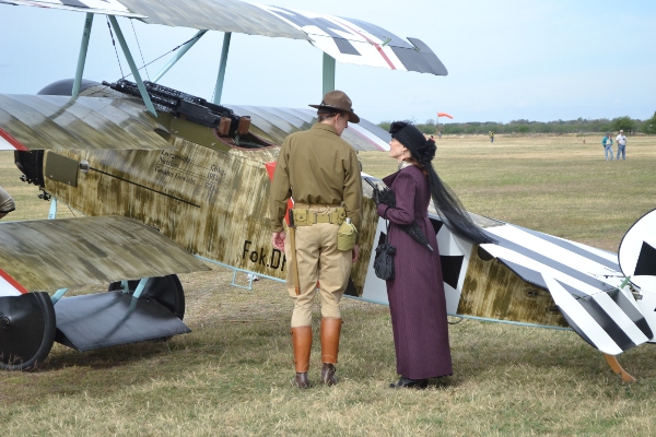 Re-enactors in period garb viewing the Fokker Dr.I